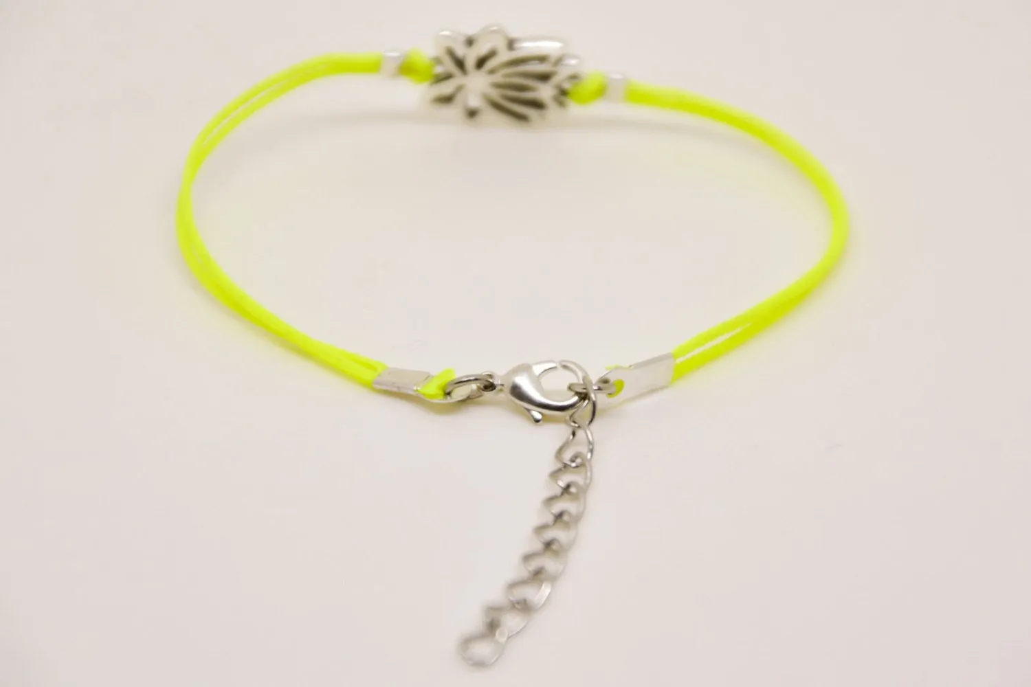 Neon yellow cord bracelet with silver lotus charm, yoga jewelry